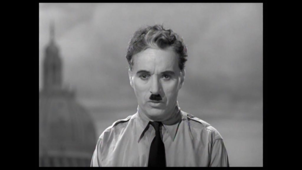 Charlie Chaplin that is posing for a picture